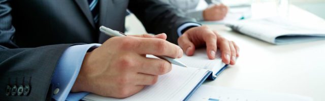 man writing down business ideas during sales training program