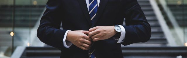 business man buttoning up his suit