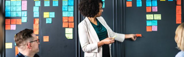 woman placing sticky notes on the wall